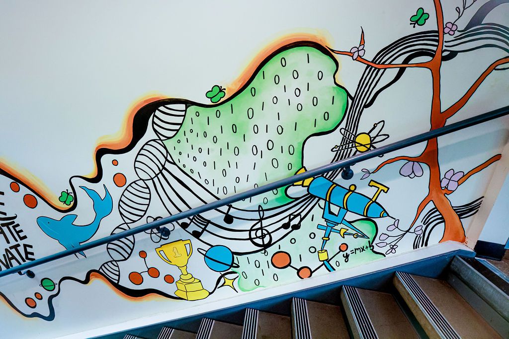 Upper wall: a DNA helix, a trophy, music notes and a telescope beneath a green binary field