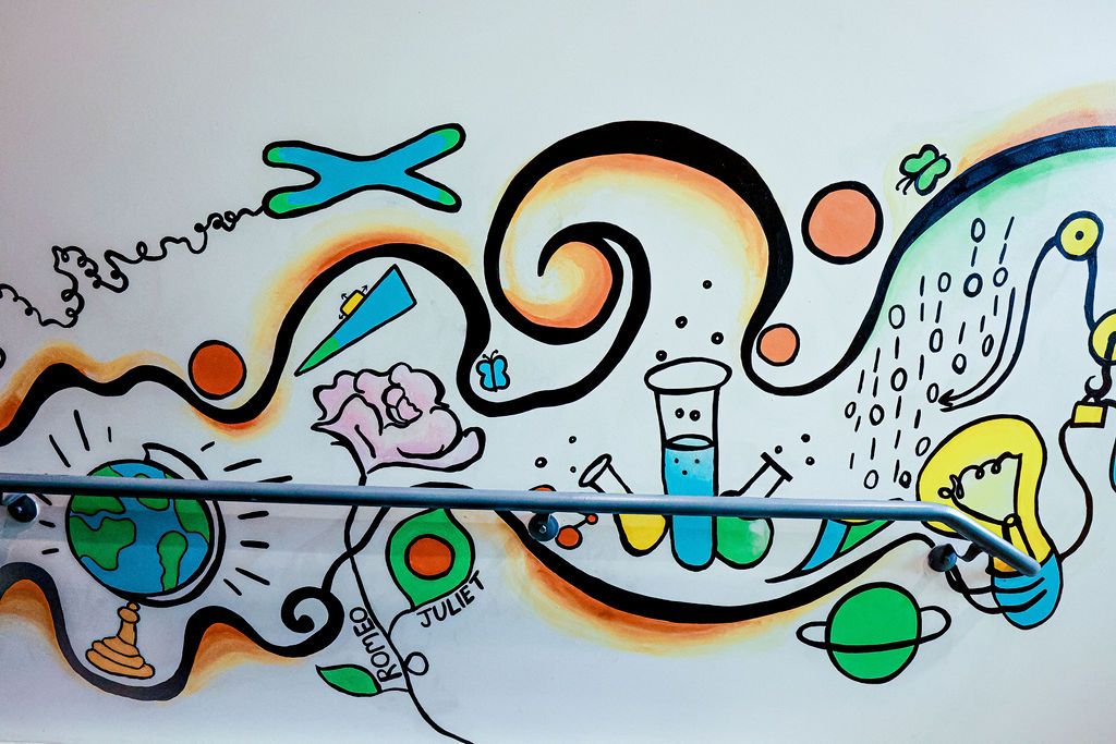 Detail: a globe, a test tube and a lightbulb along the flowing band